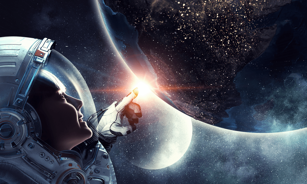 a female astronaut holds out a glowing finger towards the distant Earth, with the moon in the background