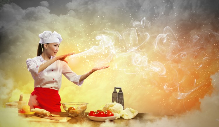 Chef woman releasing a stream of magic with food on the table in front of her