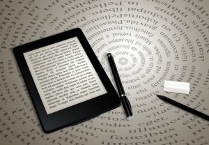 modern ebook reader on book on abstract font background