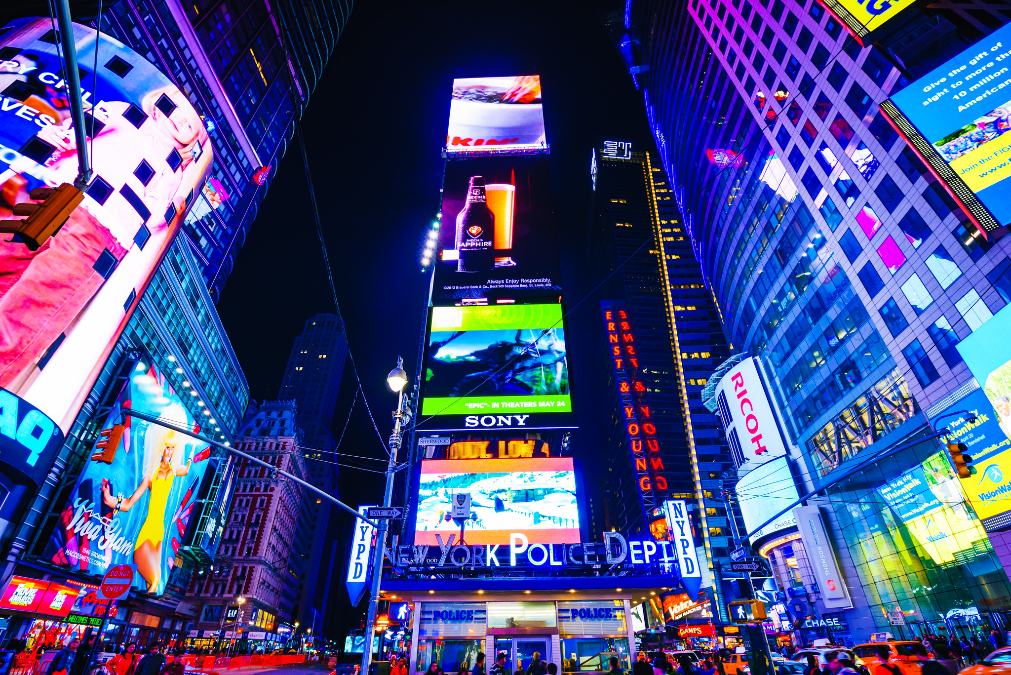 Photo of Times Square, New York City at night, looking up at the billboards