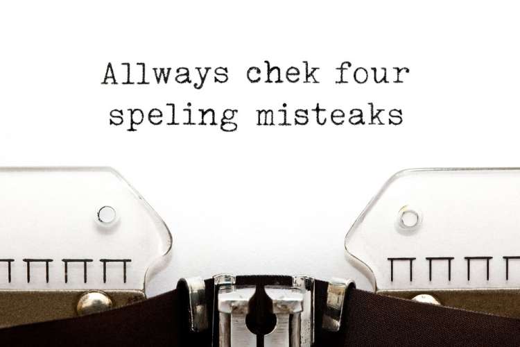 Close-up of a typewriter page. It sais "Allways chek four speling misteaks."