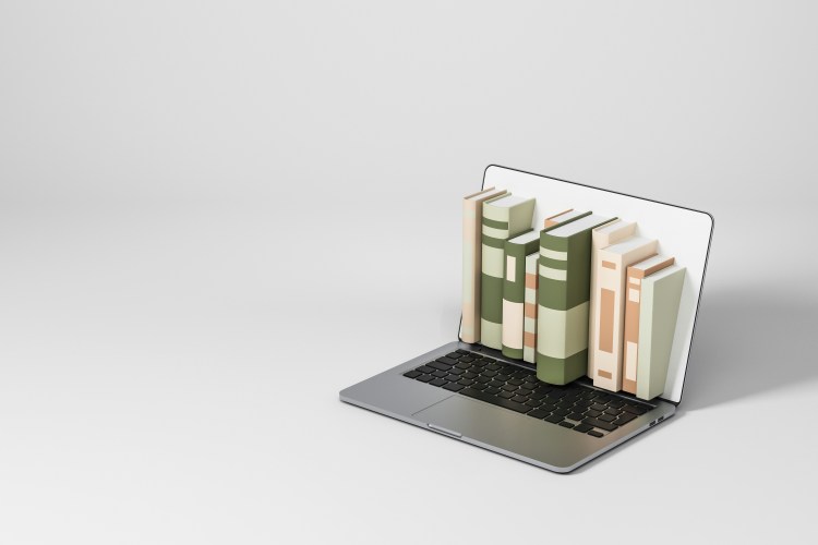 Plot device concept, a laptop sitting on a blank background with a shelf of books coming out of the screen