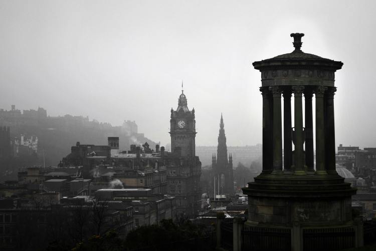 photo of Calton Hill in Scotland with a gray sky
