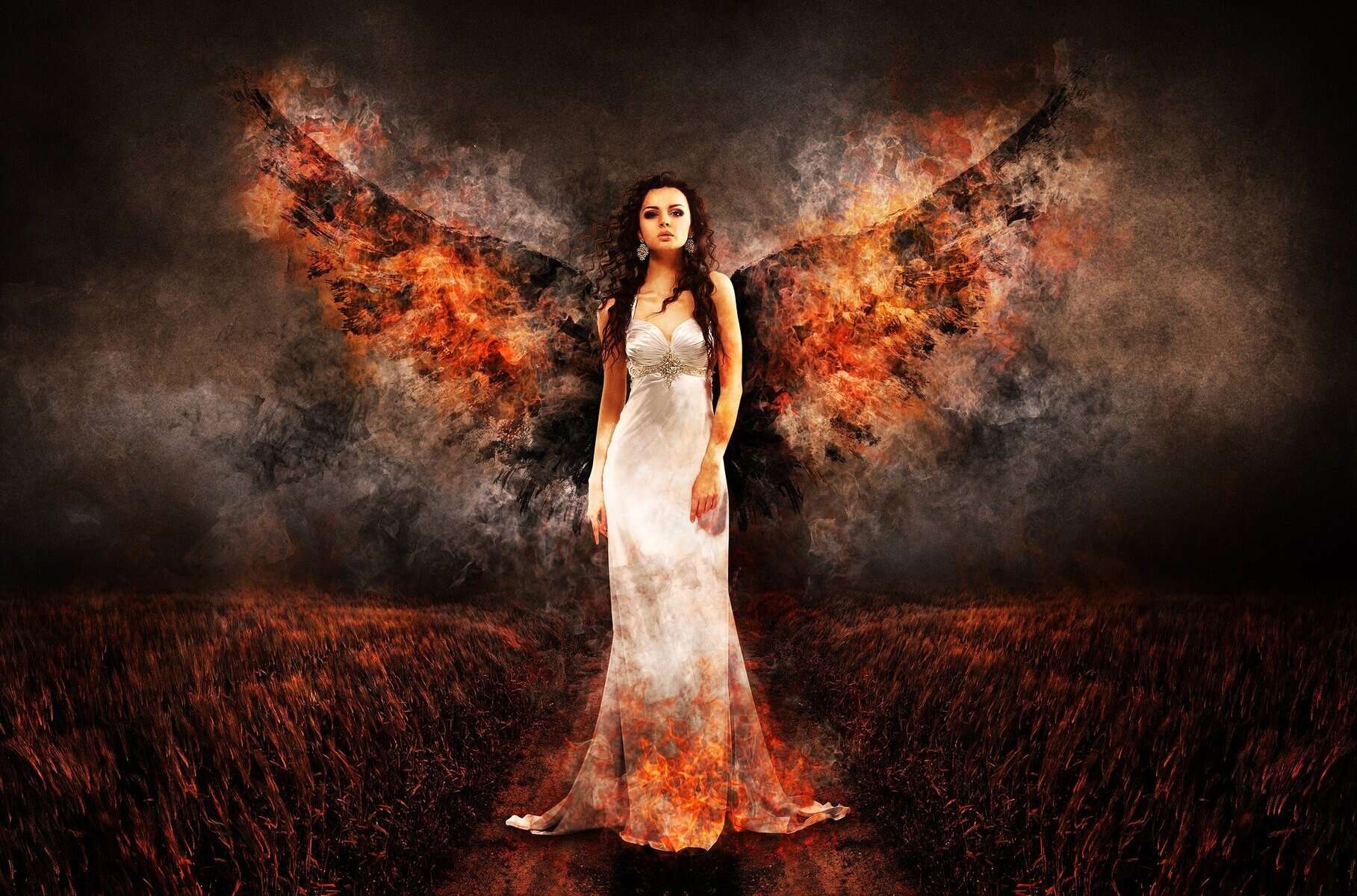 Image of a woman in a white dress with burning wings spread out behind her. The crops around her are burning and the sky is ash and smoke